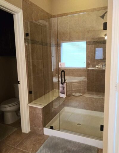 Light Brown Bathroom With Frameless Shower Door