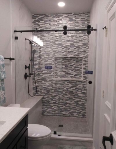 Modern Themed Bathroom With Semi Frameless Slide Shower Door